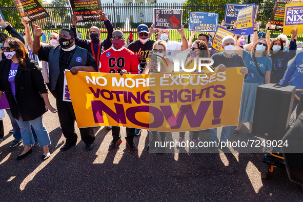 Voting rights activists hold a brief rally before a civil disobedience action at the White House.  Demonstrators are demanding that the Bide...