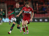  Middlesbrough's Paddy McNair in action with Barnsley's Cauley Woodrow during the Sky Bet Championship match between Middlesbrough and Barns...