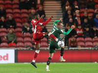Middlesbrough's Isaiah Jones in action with Callum Brittain of Barnsley  during the Sky Bet Championship match between Middlesbrough and Bar...