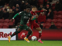 Middlesbrough's Marcus Tavernier battles with Barnsley's Aaron Leya Iseka  during the Sky Bet Championship match between Middlesbrough and B...