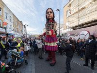 LONDON, UNITED KINGDOM - OCTOBER 22, 2021: Little Amal, a 3.5 metre-tall giant puppet representing a nine-year-old Syrian refugee child, is...