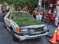 The Garden Car is filled with soil and plants by volunteers as a community project to reclaim the environment in Toronto's Kensington Market...