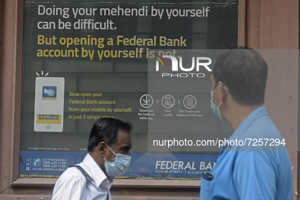 A man sees an advertisement board of a Federal Bank branch in Kolkata, India, 22 October, 2021. Federal Bank on Friday reported a standalone...