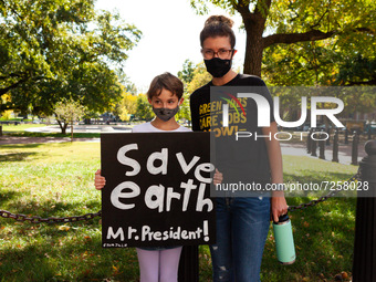 Mother and child attend a rally in support of 5 people on hunger strike at the White House for climate solutions and jobs. (