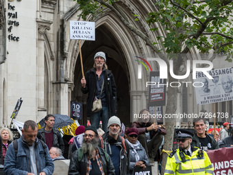 LONDON, UNITED KINGDOM - OCTOBER 23, 2021: Demonstrators take part in a rally outside the Royal Courts of Justice in solidarity with Julian...