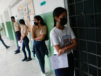 Students line up to get immunized against Covid-19 with the compound manufactured in China Sinopharm at a high school in the west of the cit...