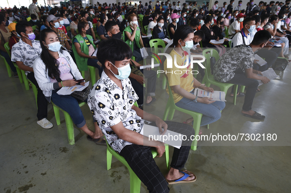 Migrant worker wait to be administered a dose of Sinovac vaccine against COVID-19 during a vaccination for migrant workers, in Bangkok, Thai...