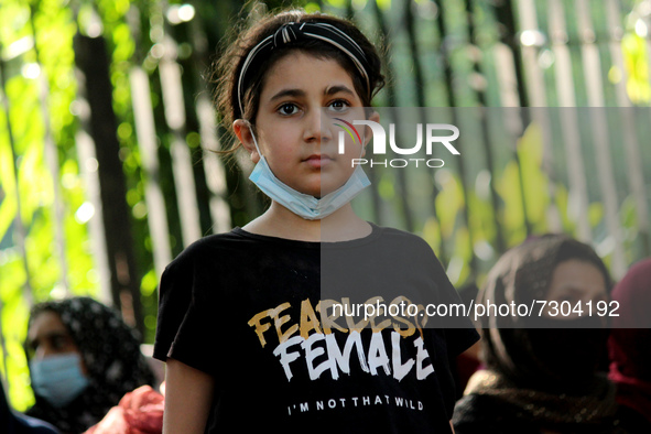 A young Afghan girl residing in India participates in a protest demanding better rights for women in Afghanistan, during a demonstration in...