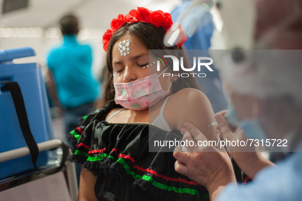 A girl dressed as a Mexican Catrina receives her first dose of the COVID-19 Vaccine as the Colombian government begins to vaccinate children...