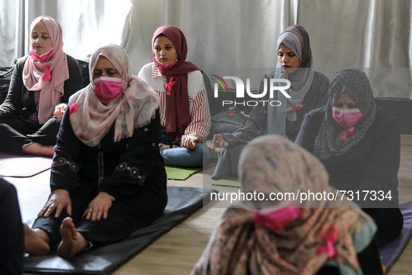 Palestinian cancer patients practise yoga during a therapy session in Gaza city on November 1, 2021. 