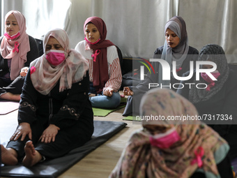 Palestinian cancer patients practise yoga during a therapy session in Gaza city on November 1, 2021. (