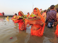 Devotees offer prayer and gifts to Sun god , during sunset time at a riverside in Kolkata , India , on 10 November 2021 , on the occasion of...