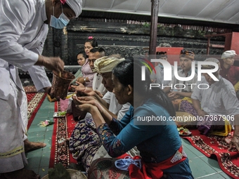 Hindu-Balinese people receive blessings as their offering prayers during the Galungan Hindu festival at Pura Agung Raksa Buana on November 1...