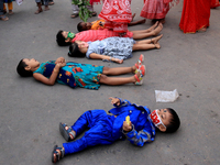 Devotees cross over children lying on the road during Chhata Puja festival. It is a ritual practiced for the well-being of children in Kolka...