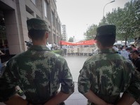 Soldiers seen guarding the hotel entrance in front of the protesters.  - Hundreds of residents from near the chemical explosion zone of Tian...