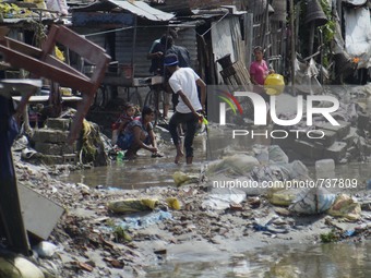 August 17, 2015, Kathmandu, Nepal – People takes out their belongings out side the houses after the floodwater entered the slum area near th...