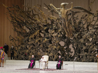 Pope Francis speaks during his weekly general audience in the Paul VI Hall at the Vatican, Wednesday, Nov. 17, 2021. At left head of the Pap...