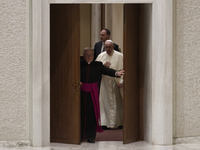 Pope Francis arrives to attend his weekly general audience in the Paul VI Hall at the Vatican, Wednesday, Nov. 17, 2021. (