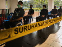 Police personnel queuing up to cast their ballots during early voting for Malacca State Election at  Malacca Police Headquarters on November...