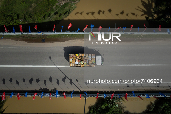 A lorry drives past the Malacca River bridge full of political parties flags at Malacca, Malaysia, on November 19, 2021. Malacca’s state leg...