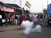 Farmers light firecrackers as they celebrate after Prime Minister Narendra Modi announced that he will repeal the controversial farm laws, a...