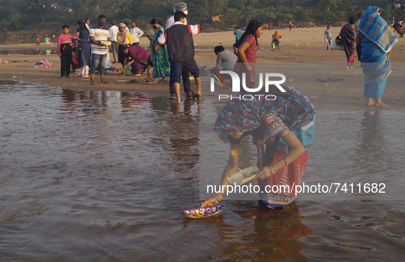 Devotees are seen on the bank of Daya river as they sail fancy boats carrying earthen lamps, coins, grains, flowers and other ritual items i...