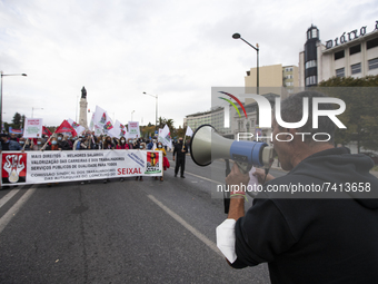 A large group of people demonstrate with posters and flags in the streets demanding better working conditions, on November 20, 2021 in Lisbo...