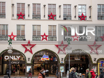 People go shopping with black friday and christmas sales in Munich, Germany on November 23, 2021. (