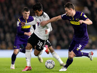 Fabio Carvalho of Fulham and Craig Forsyth of Derby County compete for the ball during the Sky Bet Championship match between Fulham and Der...