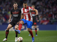 Luis Suarez of Atletico Madrid and Alessio Romagnoli of Milan compete for the ball during the UEFA Champions League group B match between At...
