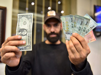 A man with US Dollars and Lebanese pounds, in Beirut, Lebanon, on November 24, 2021. (