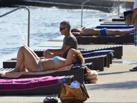 Croatian weather: Tourists and local enjoying in the summer sunshine on  21st Aug, 2015.Preko,Ugljan island,adriatic sea, Croatia (