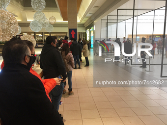 Customers line up to enter an Apple store at a shopping mall the day before Black Friday in Toronto, Ontario, Canada, on November 25, 2021....