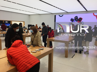 Customers look at products at an Apple store at a shopping mall the day before Black Friday in Toronto, Ontario, Canada, on November 25, 202...