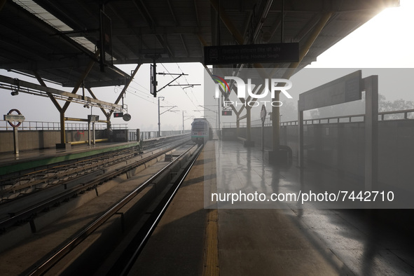 A Delhi metro train approaches towards a platform on a cold winter morning in New Delhi, India on November 26, 2021.  