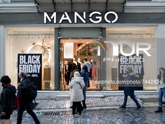 People are shopping from a Mango shop during Black Friday sales discounts in the center of Athens, Greece on November 26, 2021. (