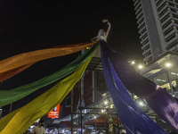 Nov 28, 2021, LGBTQ bridesmaids stand on scaffolding with LGBTQ flags demanding amendments to equal marriage laws. (