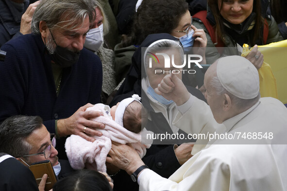 Pope Francis cheers at a newborn at the end of his weekly general audience in the Paul VI Hall at the Vatican, Wednesday, Dec. 1, 2021.  