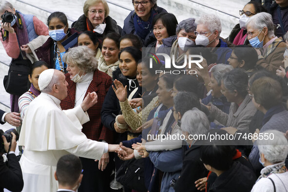Pope Francis poses for photos with participants into his weekly general audience in the Paul VI Hall at the Vatican, Wednesday, Dec. 1, 2021...