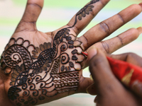 Henna (mehndi) is applied to the hands of a Hindu woman in preparation for the festival of Diwali in Toronto, Ontario, Canada, on November 0...