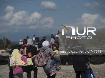 Migrants are heading towards the train station in Gevgelija, at the new refugee camp at the Macedonian-Greek border, August 23 2015, near th...