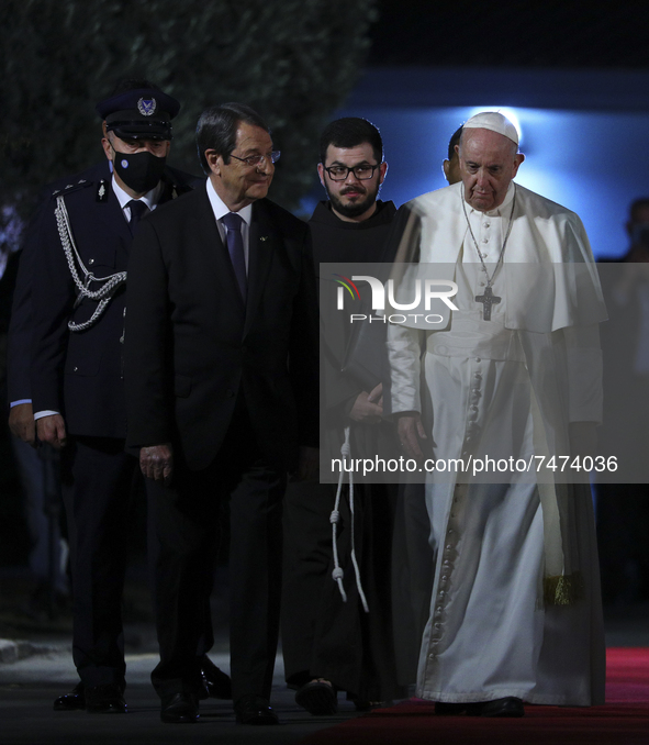 President of Cyprus Nicos Anastasiades, left, and Pope Francis review the honor guard at the Presidential Palace in Nicosia, Cyprus, Thursda...