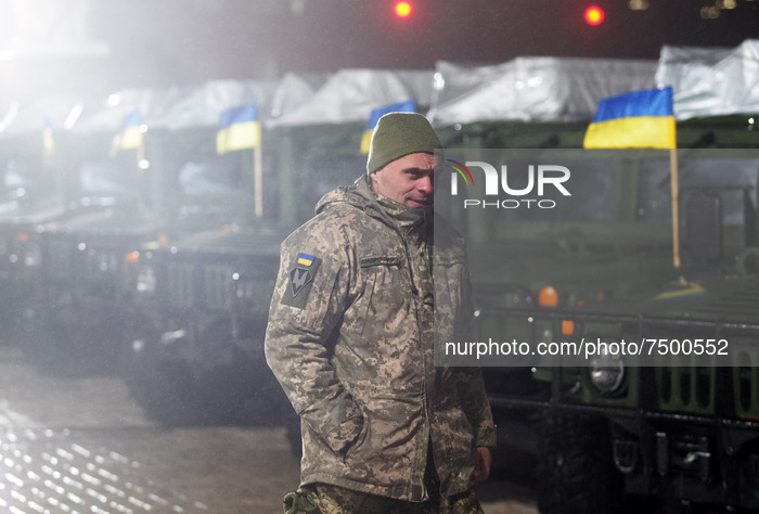 An Ukrainian serviceman walks before an official ceremony to hand over of 13 'High Mobility Multipurpose Wheeled Vehicle' (HMMWV, aka Humvee...