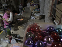 Josefina Aguilar, an engineer, makes handmade blown glass spheres at the Mexican cooperative JJL Esferas Navideñas, located in Tláhuac, Mexi...