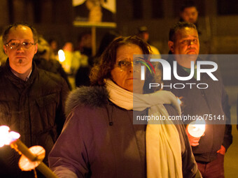 People participate in a candle rally in L'Aquila on April 6, 2014 to commemorate the fifth anniversary of the major earthquake which struck...