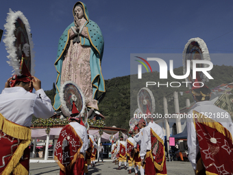 Dancers and pilgrims perform the Dance of the Quetzals in the square of the Monumental Virgin of Guadalupe located in the Sierra Norte de Xi...
