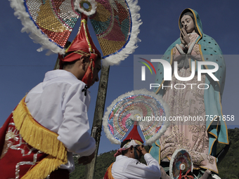 Dancers and pilgrims perform the Dance of the Quetzals in the square of the Monumental Virgin of Guadalupe located in the Sierra Norte de Xi...
