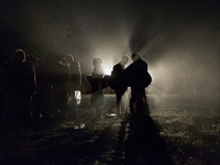 Somewhere between Greece and FYRoM (Macedonia), Syrian refugees are walking in the dark to cross the border under strict surveillance of Gre...