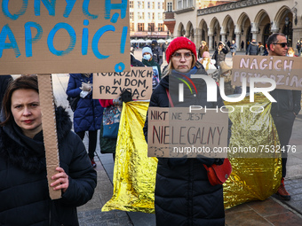 A woman (center) holds a banner reading 'No one is illegal' while attending 'Where is Eileen?' protest at the Main Square to demonstrate aga...