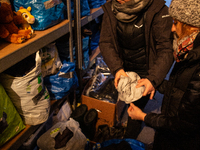 Volunteers, Agata and Karolina of Ocalenie (Salvation) Foundation sort goods aimed for migrants arriving from Bielarus - Sokolka, podlaskie...
